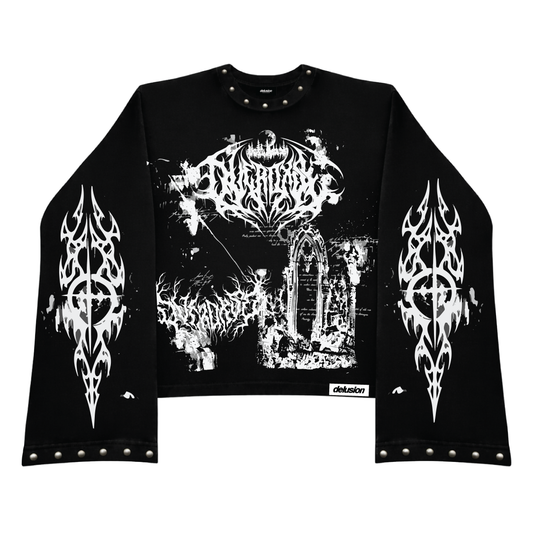 A black long-sleeve crop top sweatshirt with white graphic prints, featuring a large central gothic band logo, a cathedral scene, and matching flame-like logos on both sleeves. The garment is decorated with silver metal studs along the collar, cuffs, and hem, and has a small 'delusion' brand label on the lower right front.