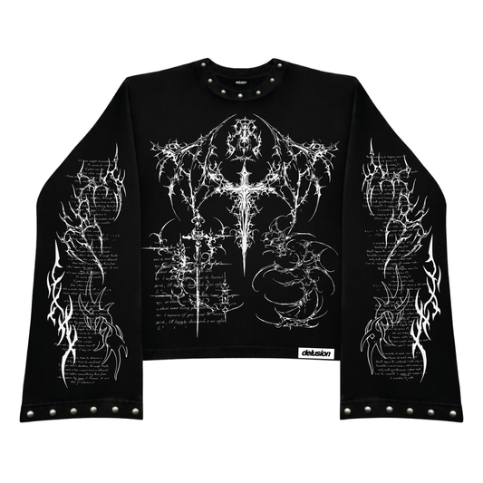 A black long-sleeve crop top tshirt featuring intricate white gothic and occult-style graphic prints on the front and sleeves, with silver metal studs on the collar, cuffs, and hem.