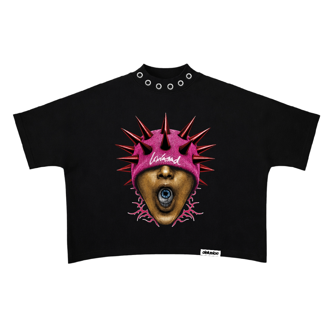 Black crop top with a graphic design of a face wearing a pink hat with spikes on a white background.