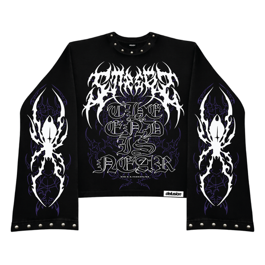 A black long-sleeve crop top sweatshirt featuring a large white gothic font graphic on the chest that reads 'The End is Near' over purple gothic background details. The sleeves have matching white gothic wing-like graphics, and the bottom hem has silver metal studs.