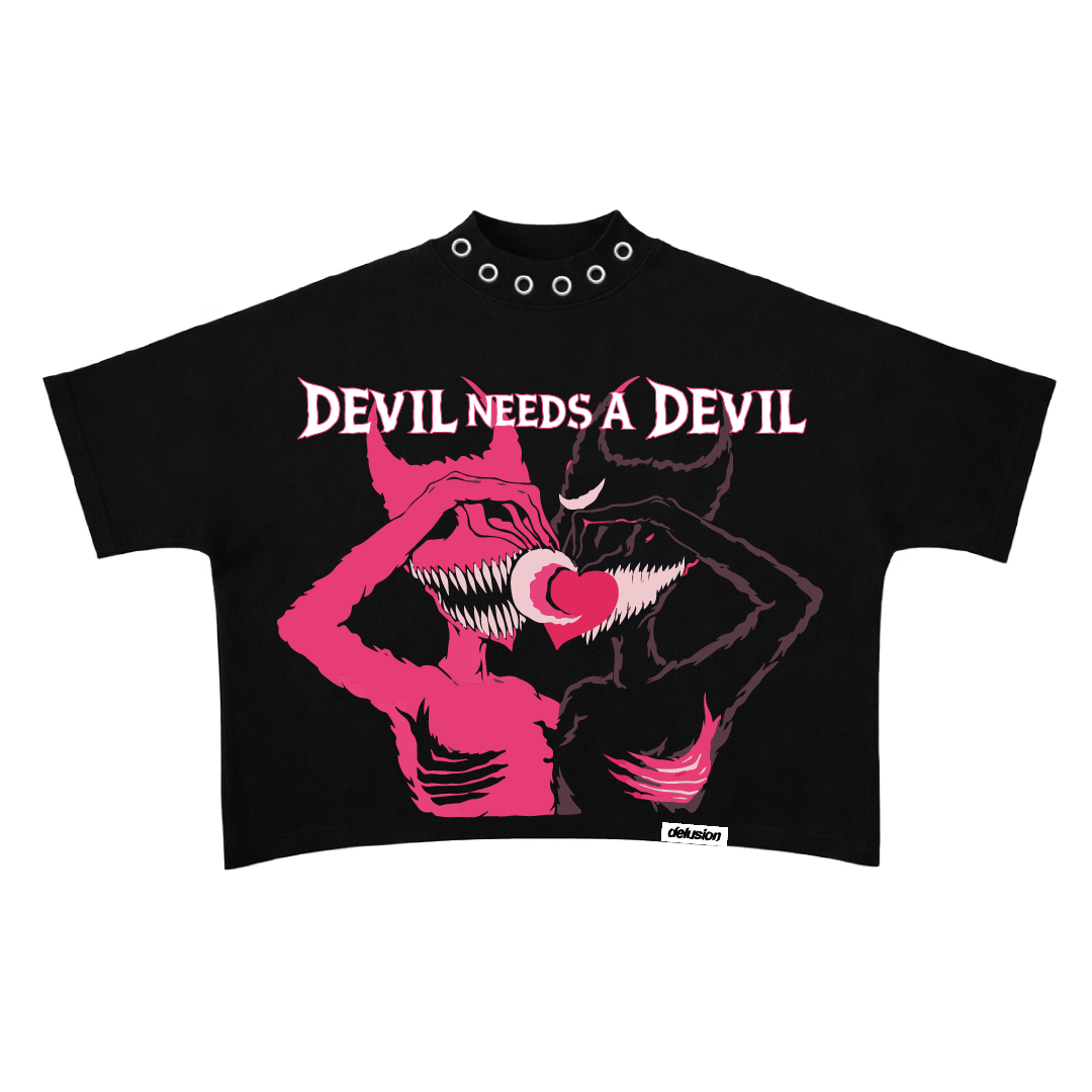 Black crop top with pink graphic design and 'Devil Needs a Devil' text on a white background