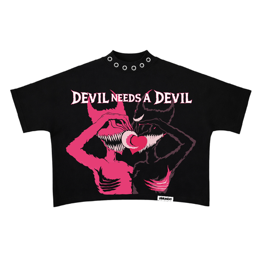 Black crop top with pink graphic design and 'Devil Needs a Devil' text on a white background